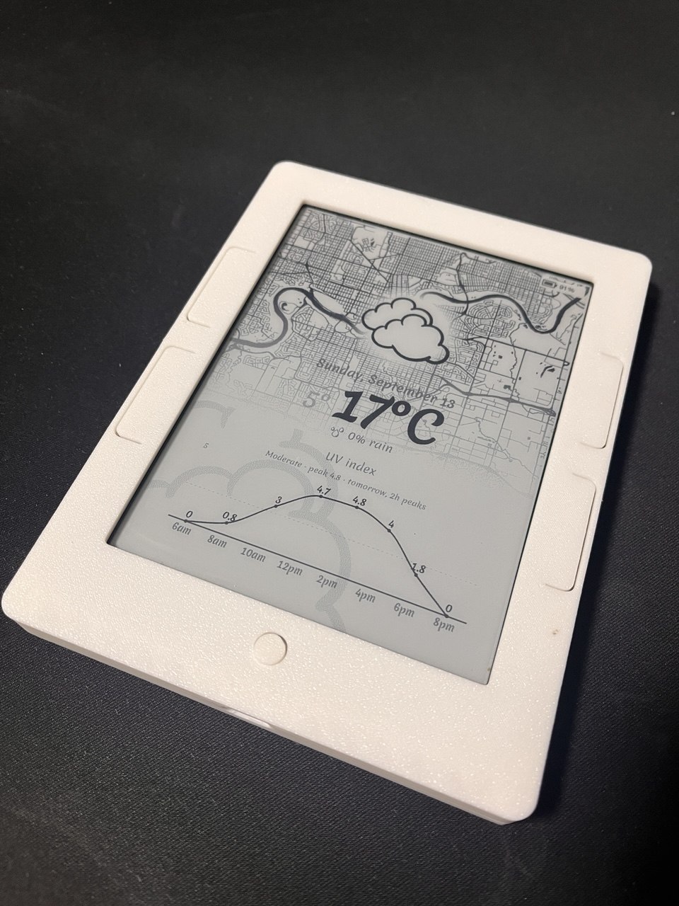 The NookPanel e-ink display showing weather and a city map